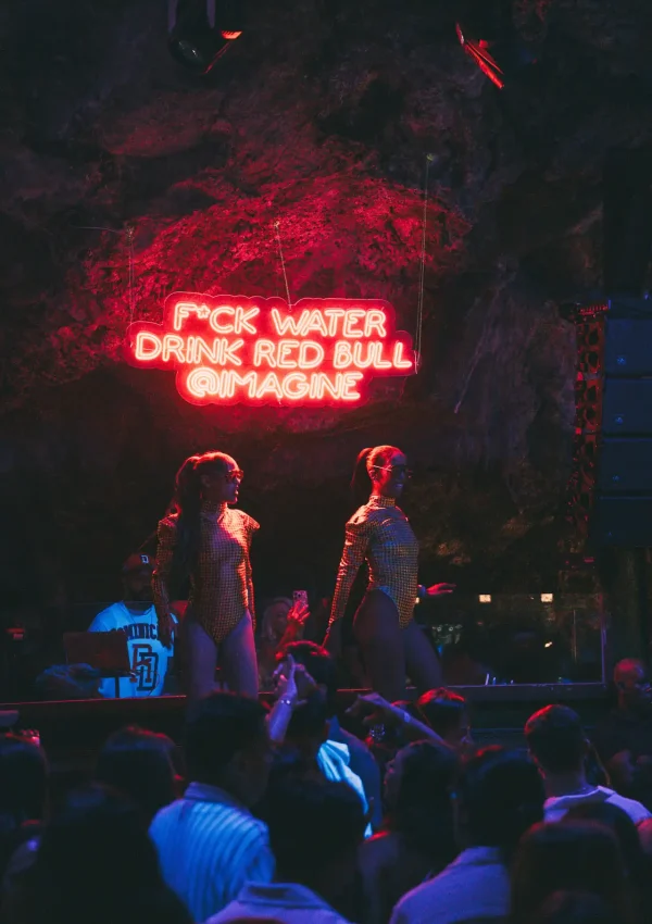 Crowd at a private event at Imagine Punta Cana, with illuminated tables and stage inside the natural cave